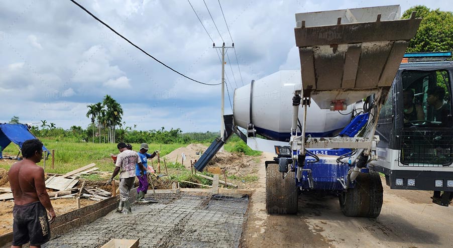 Self loading concrete mixer